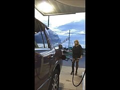 Gassing up in mini-dress